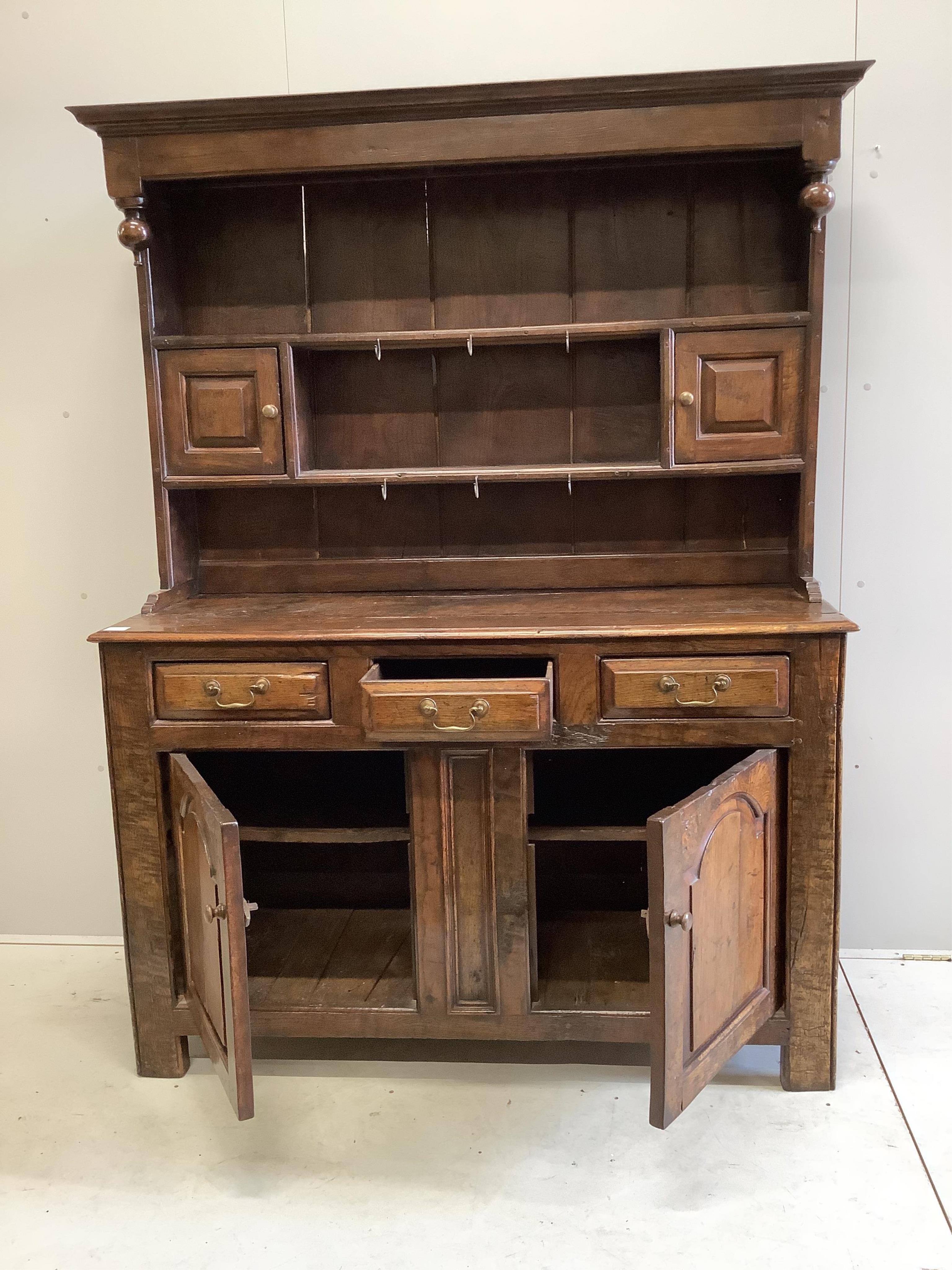 An early 18th century oak dresser, width 142cm, depth 52cm, height 188cm. Condition - fair